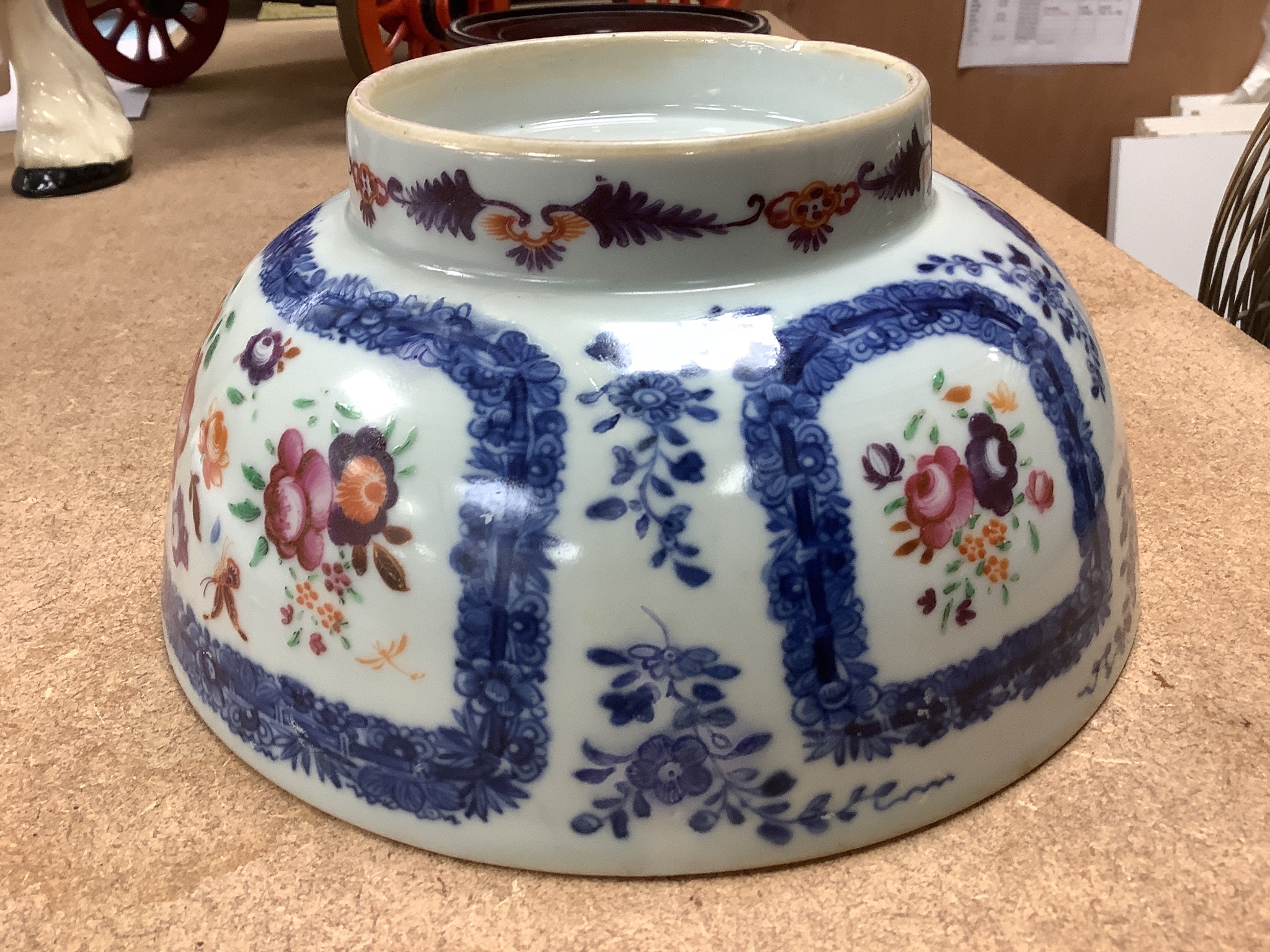 A 18th century Chinese export porcelain footed punch bowl on hardwood stand, diameter 20cm, restored